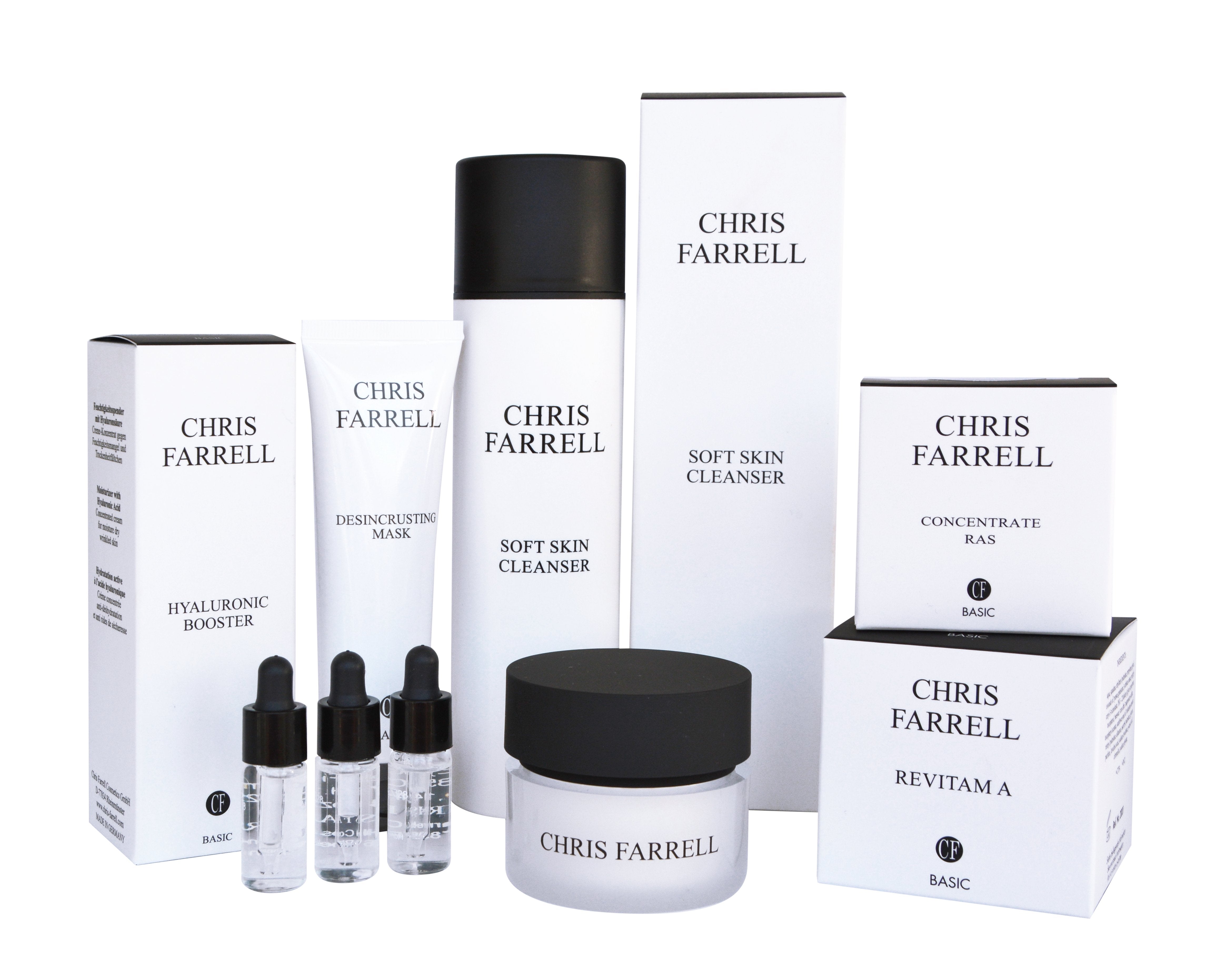 Ein Set von Chris Farrell Hautpflegeprodukten, einschließlich Flaschen, Tiegeln, Tuben und Schachteln, die zusammen angeordnet sind.